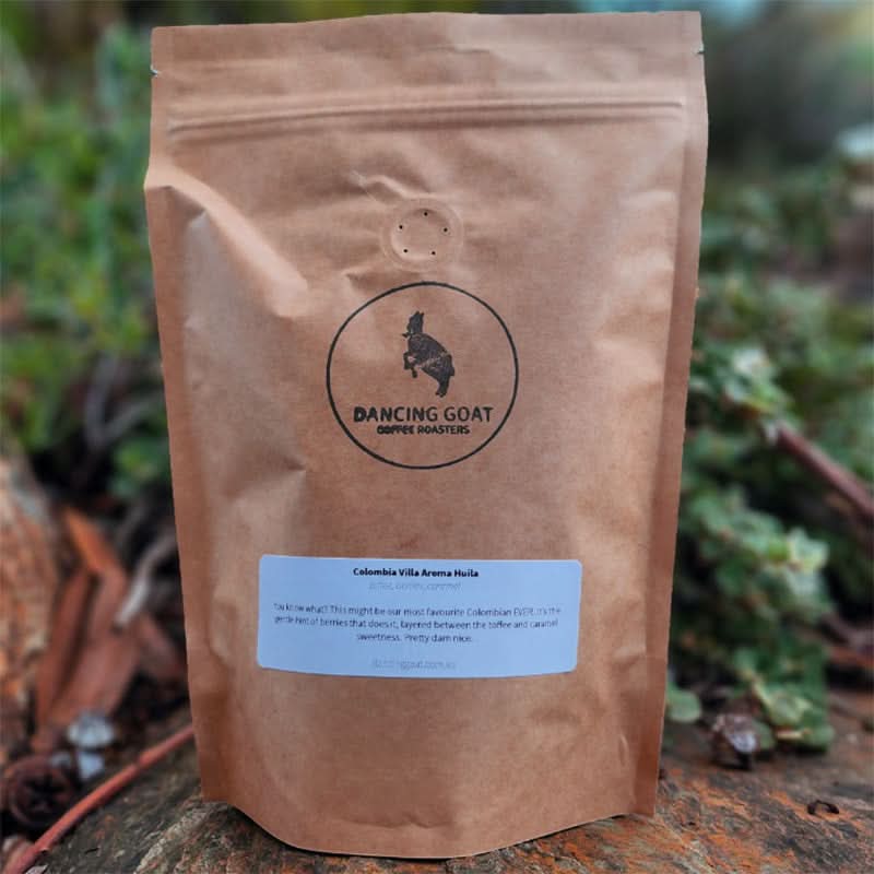 Dancing Goat Coffee Roasters Colombia Villa Aroma Huila coffee beans in brown bag outdoors